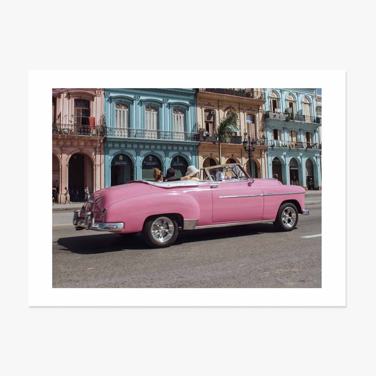 Vintage pink car on the street poster